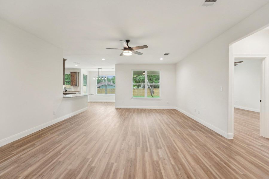 Living room with visible vents, baseboards, recessed lighting, Vinyl Wood Plank floor, and ceiling fan Living room with visible vents, baseboards, recessed lighting, Vinyl Wood Plank floor, and ceiling fan