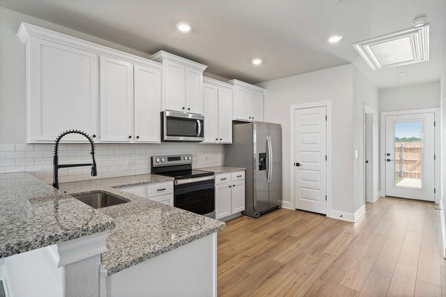 With its stainless steel appliances, granite countertops, and white cabinets, the kitchen is a stylish focal point that adds to the overall ambiance of the Arc.