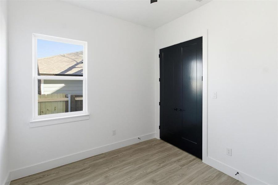 Unfurnished bedroom with light wood-type flooring and a closet