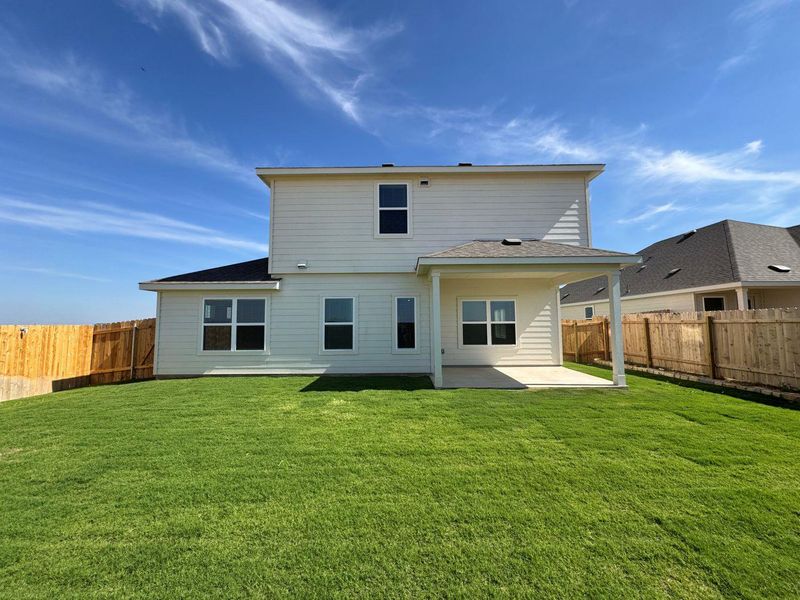 Back of property featuring a patio, a fenced backyard, and a shingled roof Back of property featuring a patio, a fenced backyard, and a shingled roof