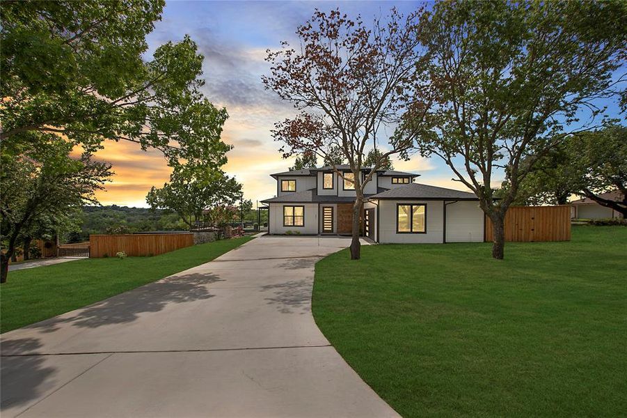 Prairie-style house featuring driveway and roof with shingles Prairie-style house featuring driveway and roof with shingles