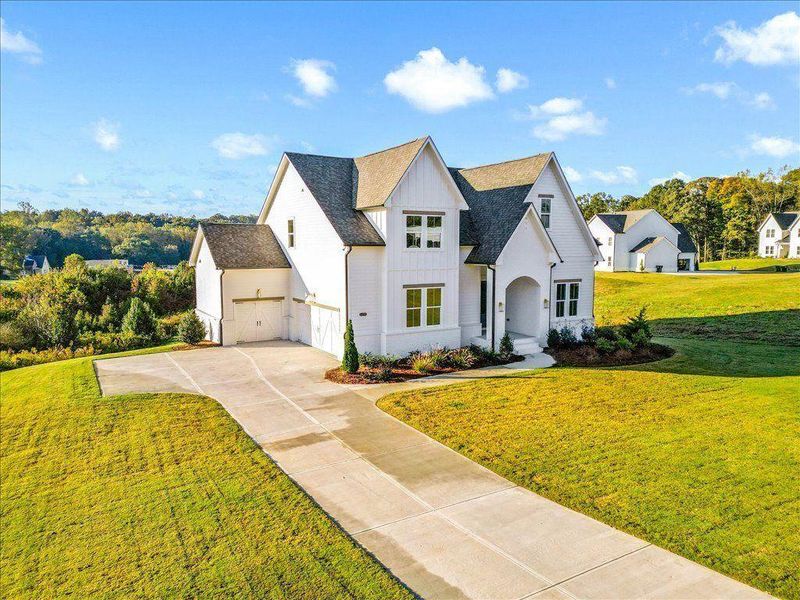 Front exterior of a new home in Brooks Pond, Cumming, GA, highlighting curb appeal (Image 22). Front exterior of a new home in Brooks Pond, Cumming, GA, highlighting curb appeal (Image 22).