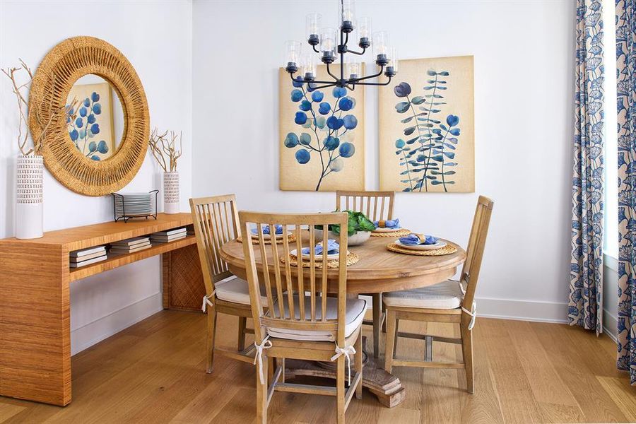 Dining space featuring light wood finished floors and a chandelier