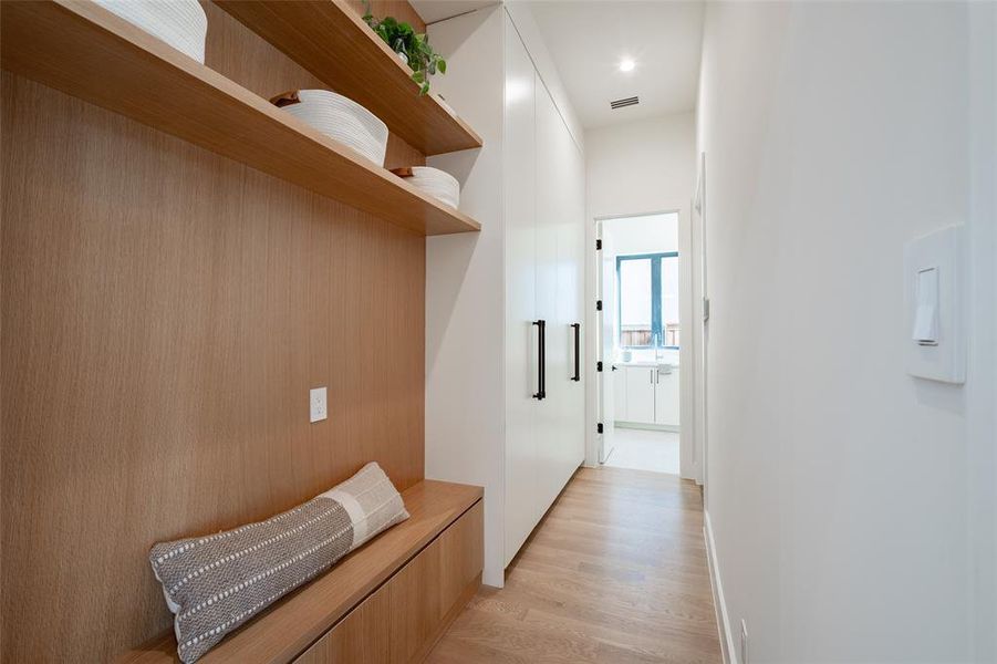 Hallway with light hardwood / wood-style floors