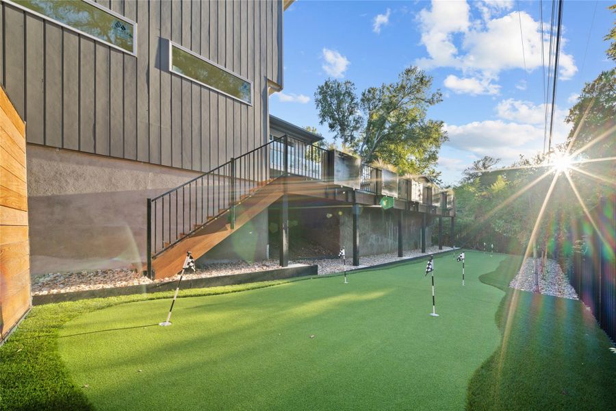 Large putting green with 7 holes in back yard