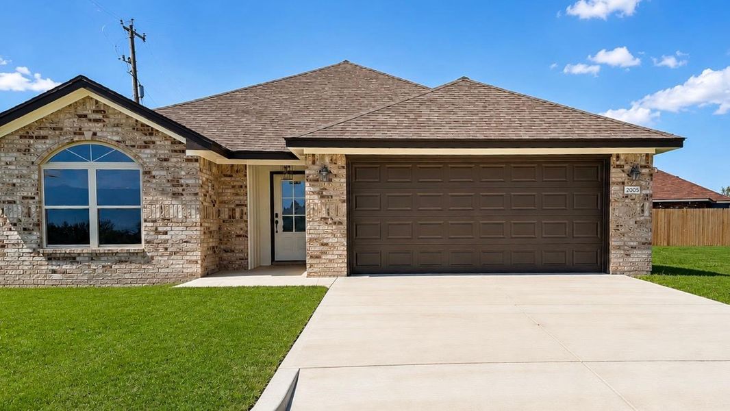 Brick facade exterior featuring a gabled roofline and an arched window Brick facade exterior featuring a gabled roofline and an arched window