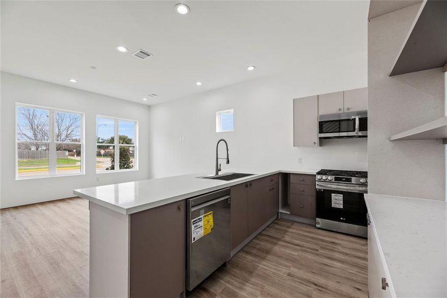 The Kitchen space offers lots of cabinet storage and designer built-ins.