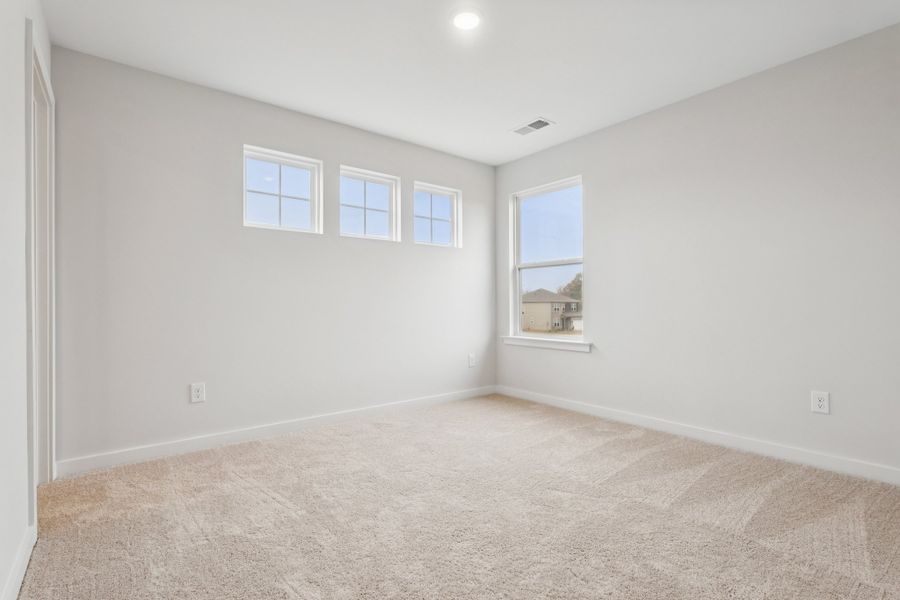 A room with a carpet and windows. A room with a carpet and windows.