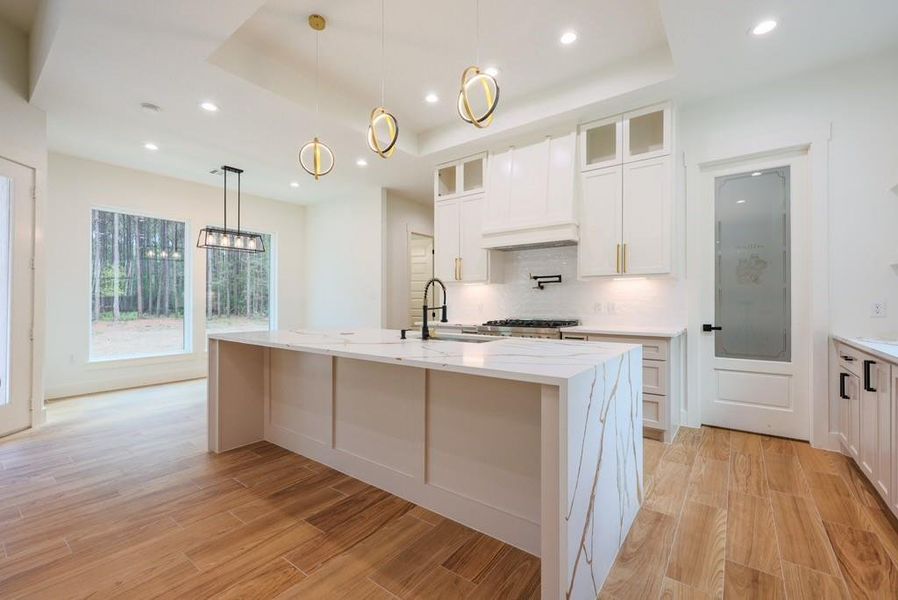 Welcome to your fully custom chefs kitchen with an oversized waterfall island. Welcome to your fully custom chefs kitchen with an oversized waterfall island.