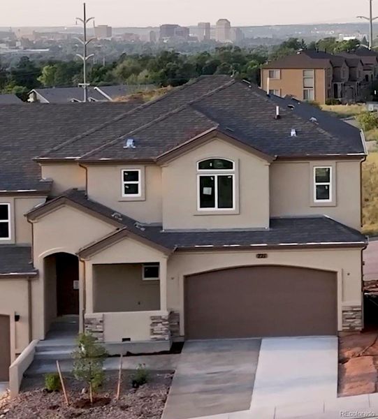 Front exterior of a new home in , Colorado Springs, CO, highlighting curb appeal (Image 1).