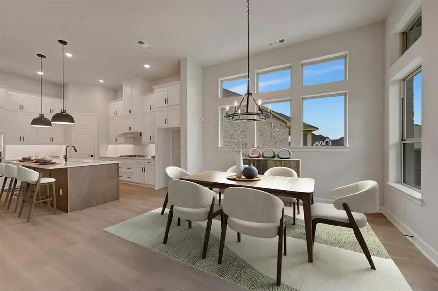 Dining space featuring a chandelier and light wood-type flooring