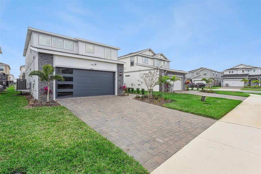 Front exterior of a new home in Windsor Cay Resort, Clermont, FL, highlighting curb appeal (Image 2). Front exterior of a new home in Windsor Cay Resort, Clermont, FL, highlighting curb appeal (Image 2).