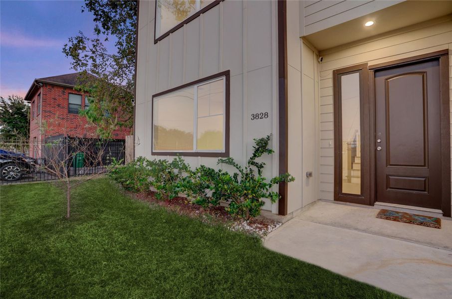 Fresh landscaping and a modern façade frame the welcoming front entry.