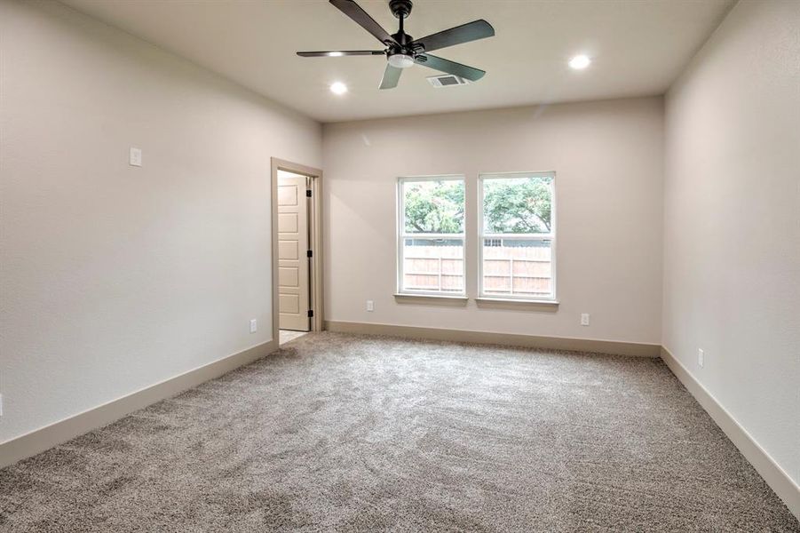 Empty room with light carpet, recessed lighting, and a ceiling fan