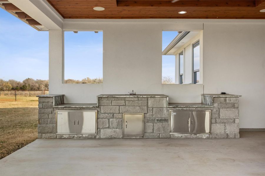 View of patio / terrace with area for grilling and cookout of the new construction main house.