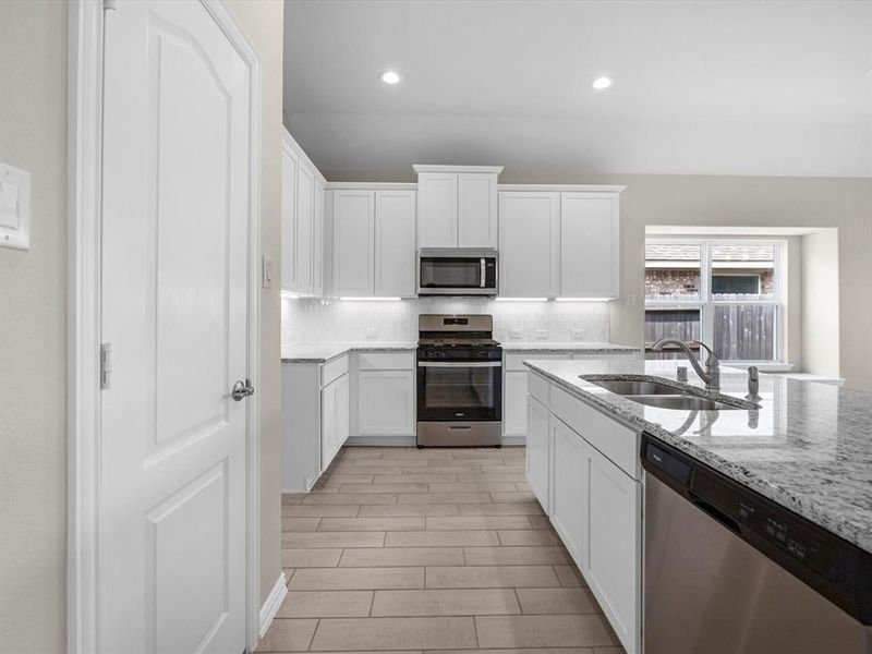 A kitchen with white cabinets. A kitchen with white cabinets.