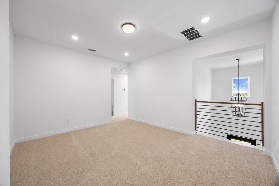 Unfurnished room with light carpet, recessed lighting, and a chandelier Unfurnished room with light carpet, recessed lighting, and a chandelier