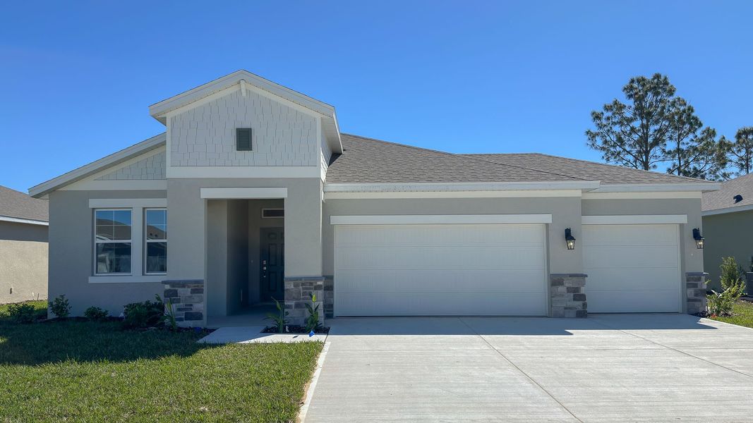 Front exterior of a new home in Archers Mill, Ormond Beach, FL, highlighting curb appeal (Image 1).