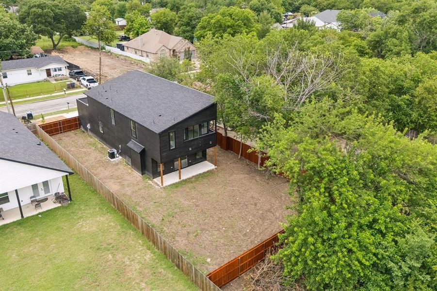 Modern two-story residence featuring a dark exterior finish and a dark shingle roof Modern two-story residence featuring a dark exterior finish and a dark shingle roof