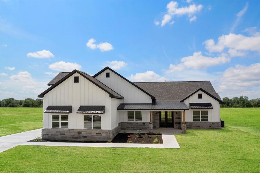Charming modern farmhouse with a spacious front lawn, nestled in a serene setting. Perfect blend of style and comfort.