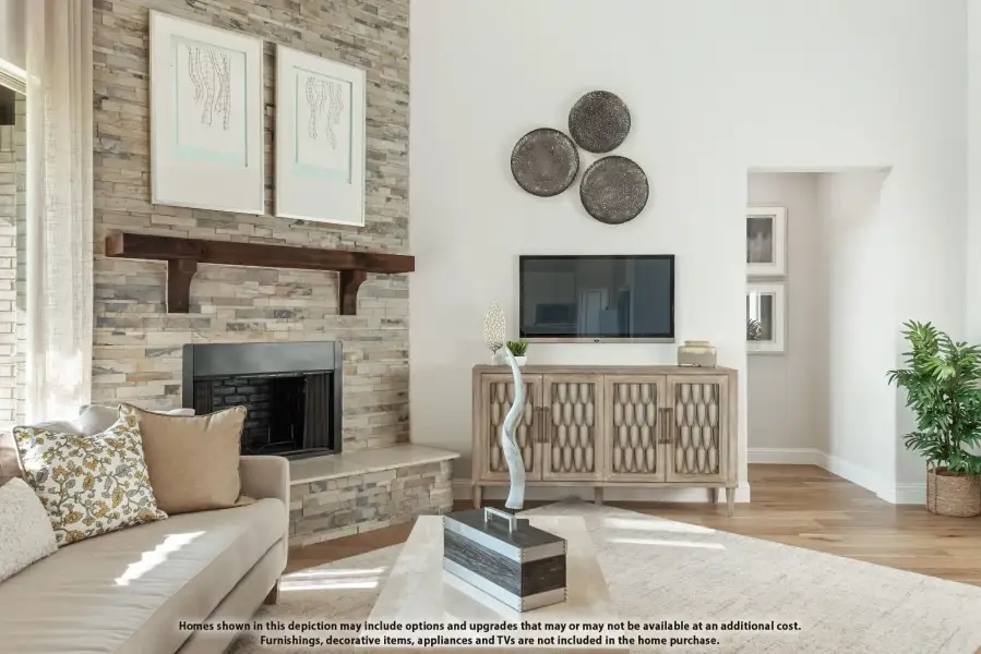 Living room with floor-to-ceiling stone fireplace, wood mantel, hardwood floors, and neutral furnishings Living room with floor-to-ceiling stone fireplace, wood mantel, hardwood floors, and neutral furnishings
