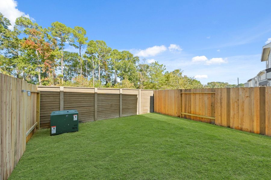 Exterior details and patio area of a home in Bridges on Lake Houston Villas, Humble (Image 3).