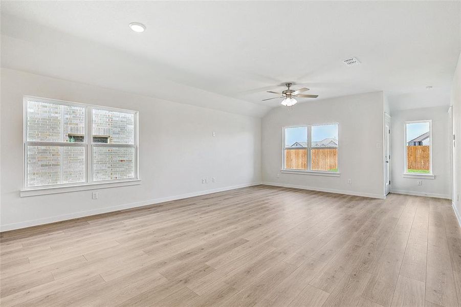 Unfurnished living room featuring light wood-type flooring and ceiling fan