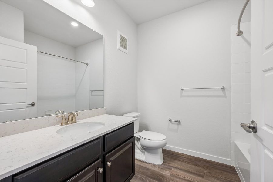 A bathroom with a sink toilet and shower.