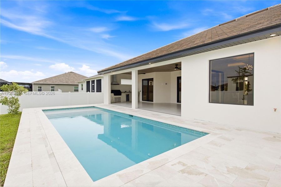 Private pool surrounded by an elegant marble deck creates a serene backyard retreat. Private pool surrounded by an elegant marble deck creates a serene backyard retreat.