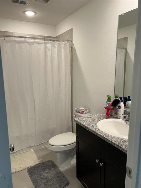 Bathroom with vanity, toilet, and tile patterned flooring Bathroom with vanity, toilet, and tile patterned flooring