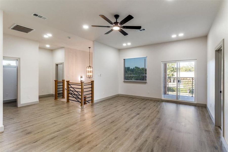 Living area with light wood finished floors, recessed lighting, a chandelier, and ceiling fan Living area with light wood finished floors, recessed lighting, a chandelier, and ceiling fan