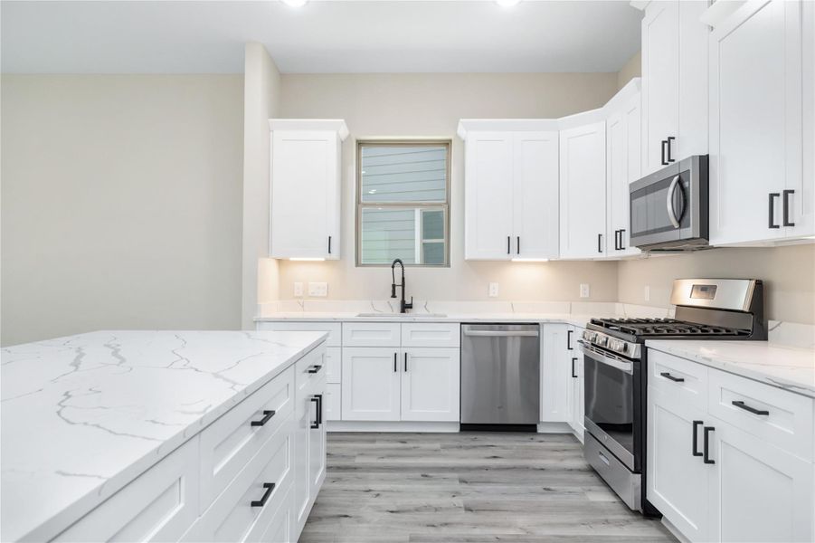 Thoughtful details such as under-cabinet lighting and soft-close drawers and cabinets enhance both the functionality and charm of the home.