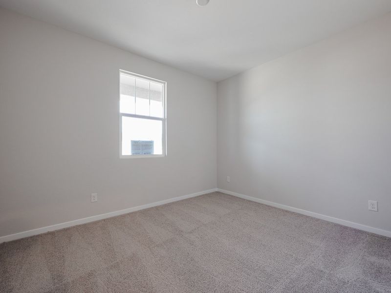 A room with a window and a carpet. A room with a window and a carpet.