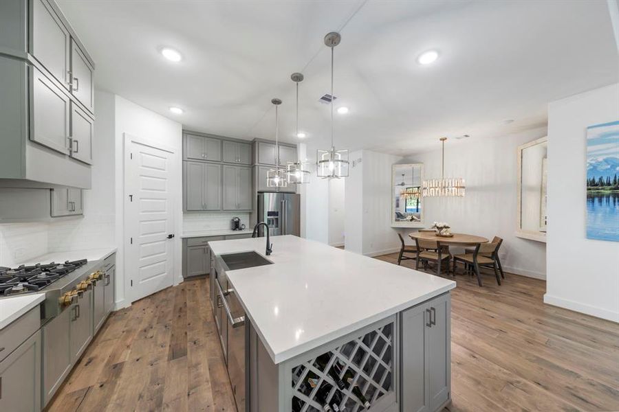 The kitchen island offers a captivating view of the dining area and family room, creating an inviting space for gatherings and seamless interactions.