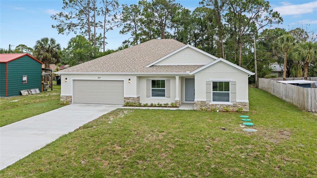 Front exterior of a new home in , Palm Bay, FL, highlighting curb appeal (Image 33).