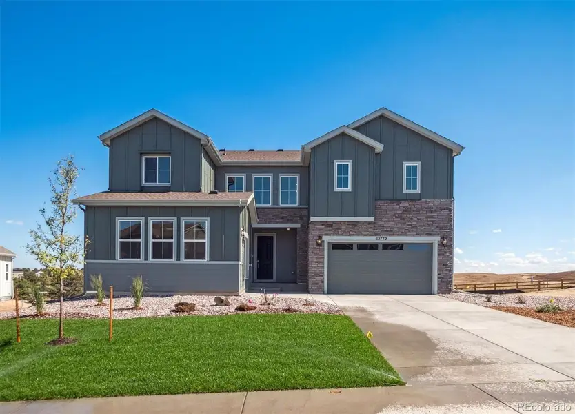 Front exterior of a new home in Trails at Smoky Hill, Parker, CO, highlighting curb appeal (Image 1).
