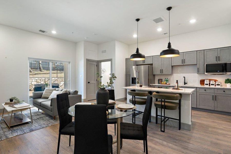 Dining area with light wood-type flooring and recessed lighting