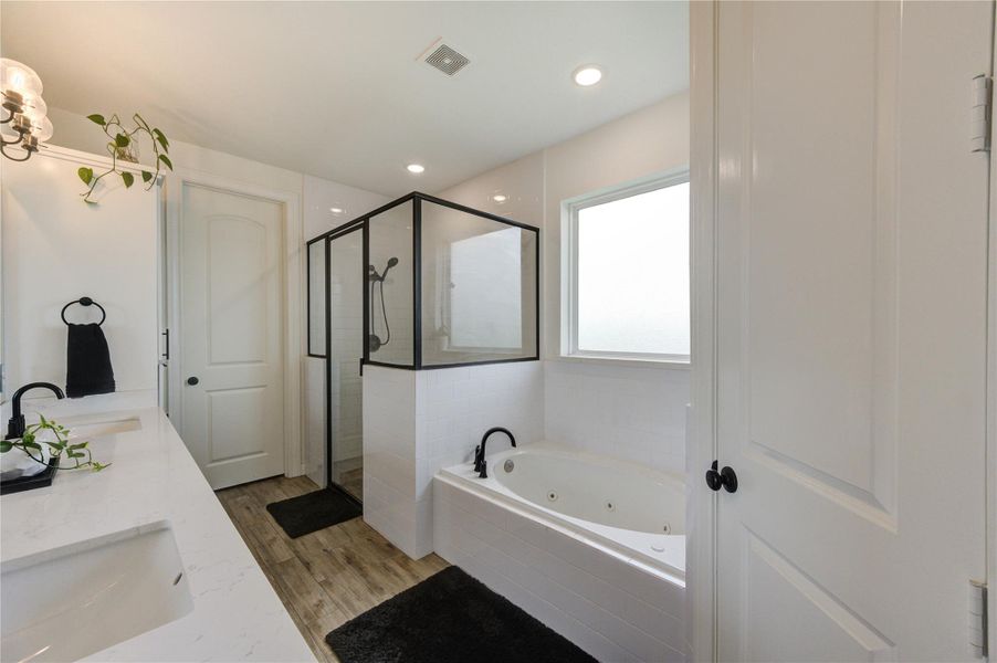 Jetted soaking tub and separate glass-enclosed shower retreat