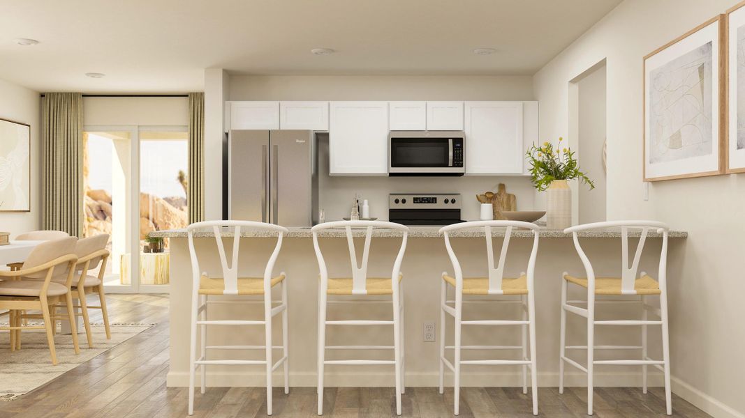 A kitchen with a table and chairs.