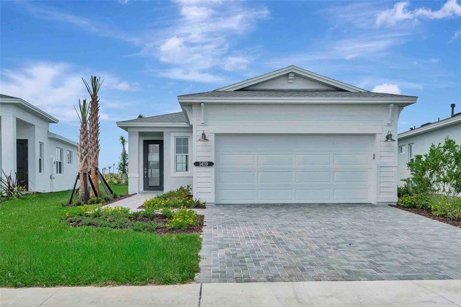 Front exterior of a new home in Cresswind at Lake Harris, Tavares, FL, highlighting curb appeal (Image 31).