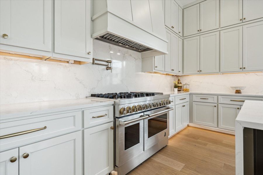 Sleek commercial style rangette with 6 gas burners, griddle, double ovens and pot iller.