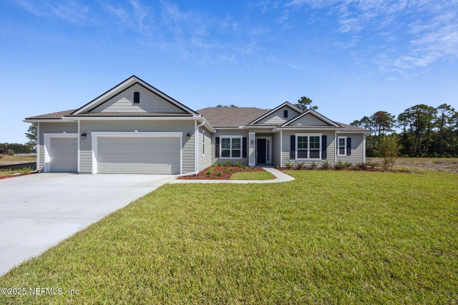 Front exterior of a new home in Katie Cove, Jacksonville, FL, highlighting curb appeal (Image 1).