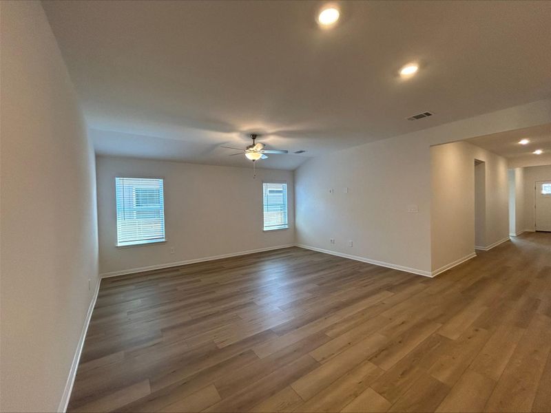 Spare room featuring recessed lighting, plenty of natural light, wood finished floors, and a ceiling fan Spare room featuring recessed lighting, plenty of natural light, wood finished floors, and a ceiling fan