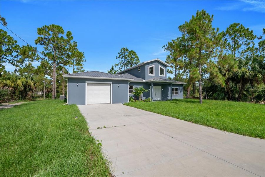 Front exterior of a new home in , Lehigh Acres, FL, highlighting curb appeal (Image 25).