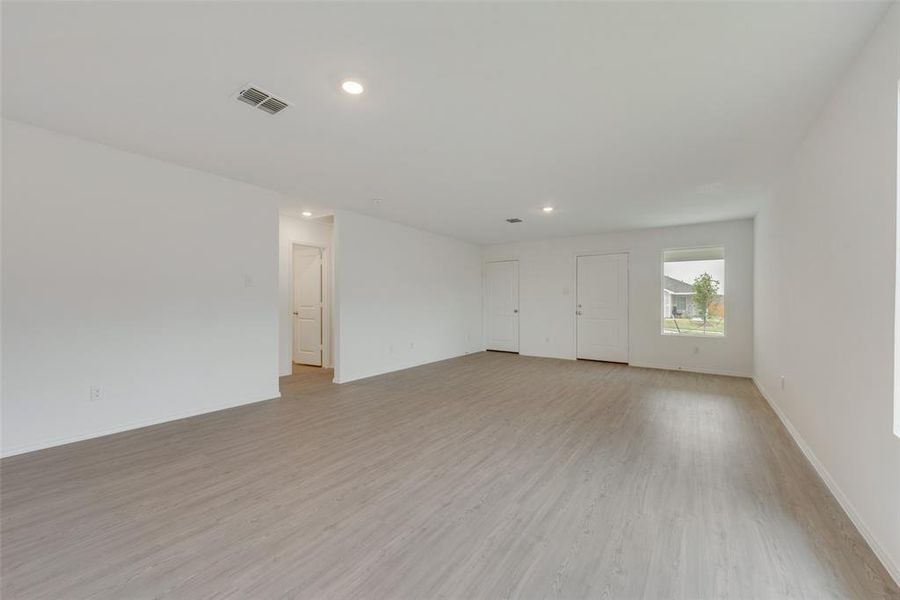 Empty room with light hardwood / wood-style floors