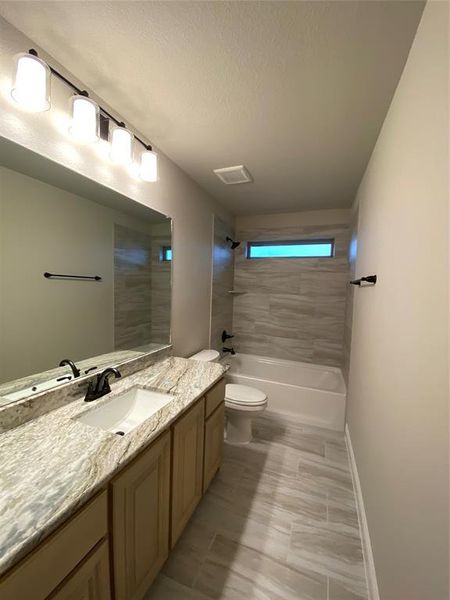 Bath 3 has window for natural light, granite, and 12x24 tile