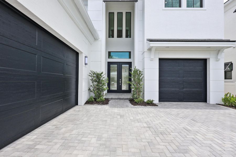 Front exterior of a new home in Artistry Palm Beach, Palm Beach Gardens, FL, highlighting curb appeal (Image 1). Front exterior of a new home in Artistry Palm Beach, Palm Beach Gardens, FL, highlighting curb appeal (Image 1).
