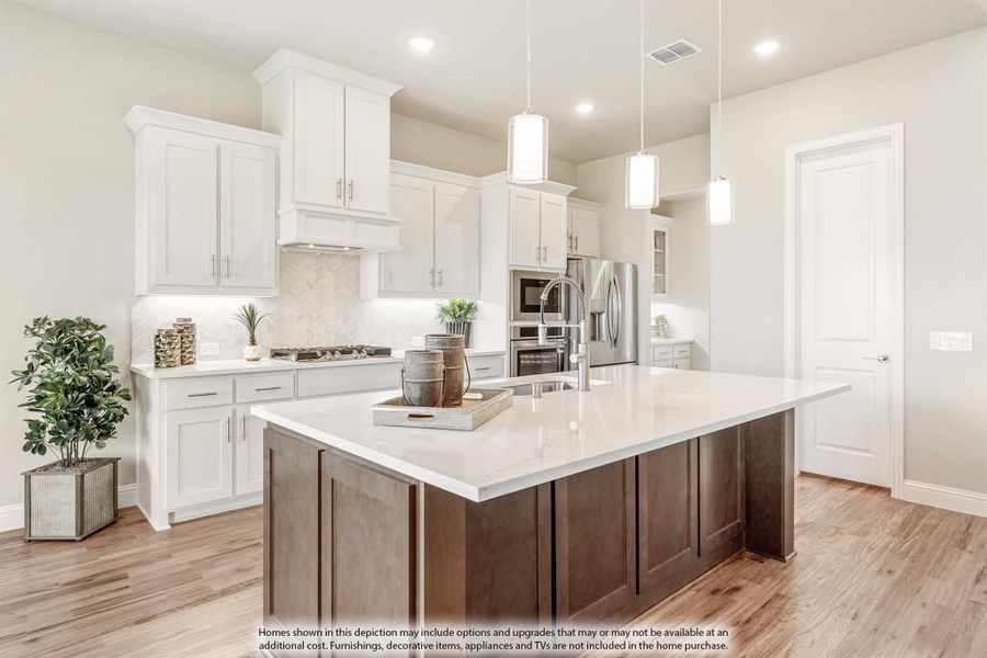 Kitchen with large dark wood island, white cabinets, quartz countertops, and stainless steel appliances on hardwood floors. Kitchen with large dark wood island, white cabinets, quartz countertops, and stainless steel appliances on hardwood floors.