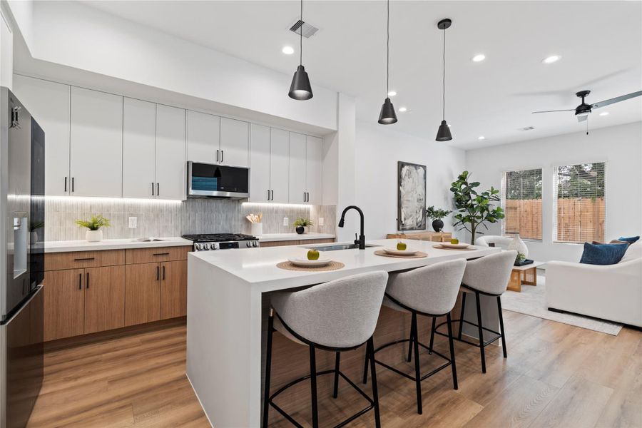 Crafted with meticulous attention to detail by Tomo Homes and Jain & Co, this home showcases exceptional quality throughout. High-end finishes like soft-close cabinetry, designer tile backsplash, and a statement quartz island reflect the thoughtful design and elevated style that define this build