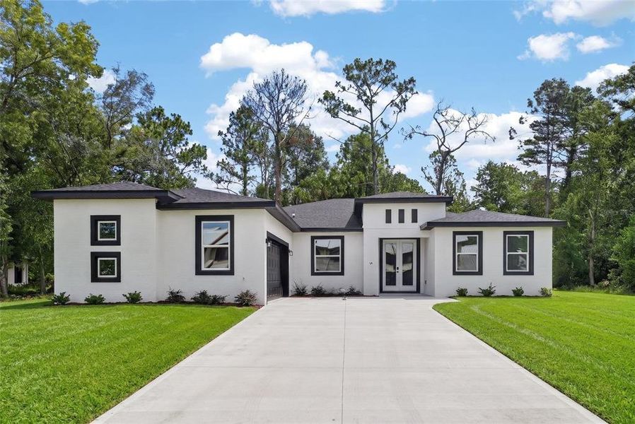 Front exterior of a new home in , Homosassa, FL, highlighting curb appeal (Image 1). Front exterior of a new home in , Homosassa, FL, highlighting curb appeal (Image 1).